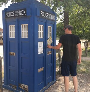 Ian entering the Tardis which is the blue police box/time-travel machine from Doctor Who