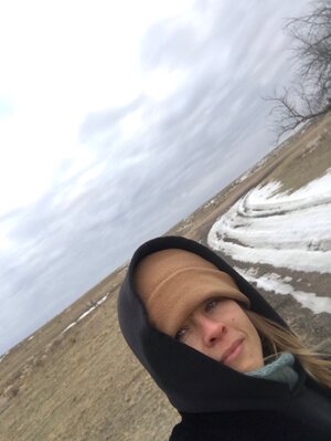 Grad Student Lila Ann Dodge stands outdoors in winter and looks to the camera.
