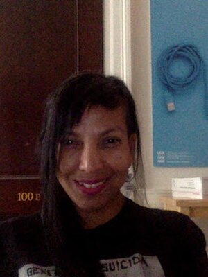 Grad Student Lettycia Terrones sits in an office and smiles at the camera