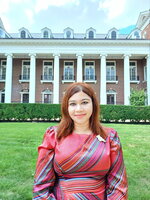 Profile photo of Camellia Paul standing in front of the English Building on the Main Quad at the University of Illinois Urbana-Champaign